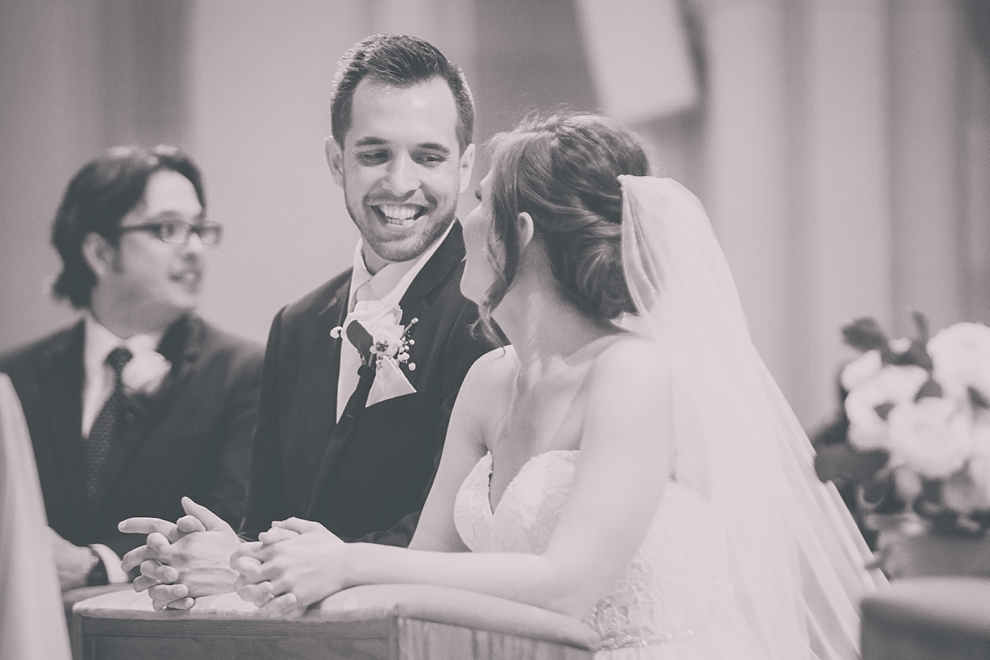 groom smiles at bride during wedding at St. Joseph's University Parish Church in Buffalo, NY