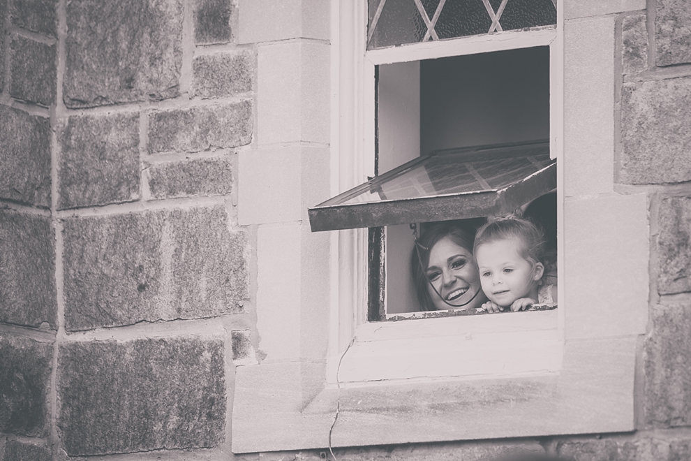 bride looks out window during wedding at St. Joseph's University Parish Church in Buffalo, NY