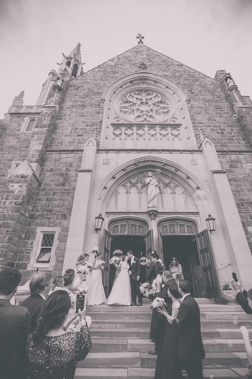 bride and groom exit church during wedding at St. Joseph's University Parish Church in Buffalo, NY