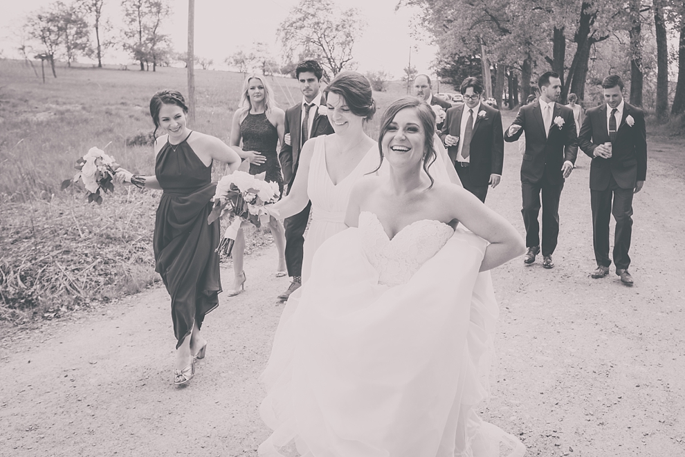 bridal party walks at Tifft Nature preserve during wedding in Buffalo, NY