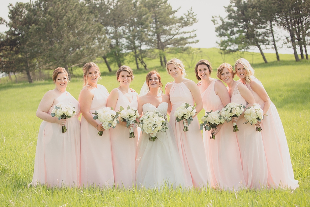 bridesmaids pose for portrait at Tifft Nature preserve during wedding in Buffalo, NY