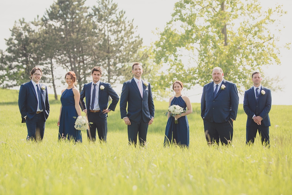 groomsen and women pose for portrait at Tifft Nature preserve during wedding in Buffalo, NY