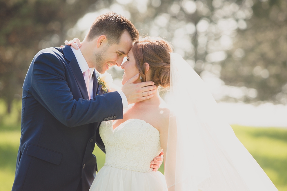 bride and groom embrace at tifft nature preserve during their wedding in Buffalo, NY