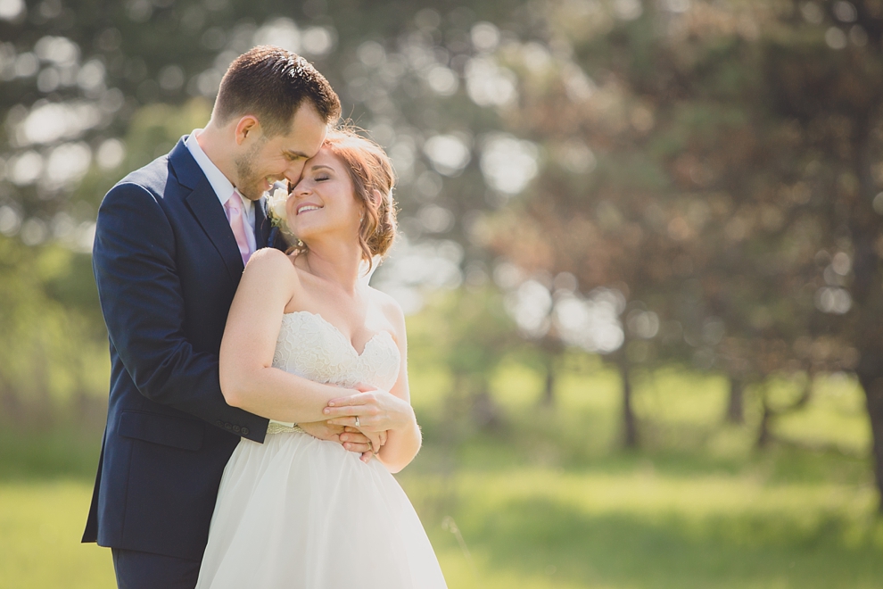 bride and groom embrace at tifft nature preserve during their wedding in Buffalo, NY
