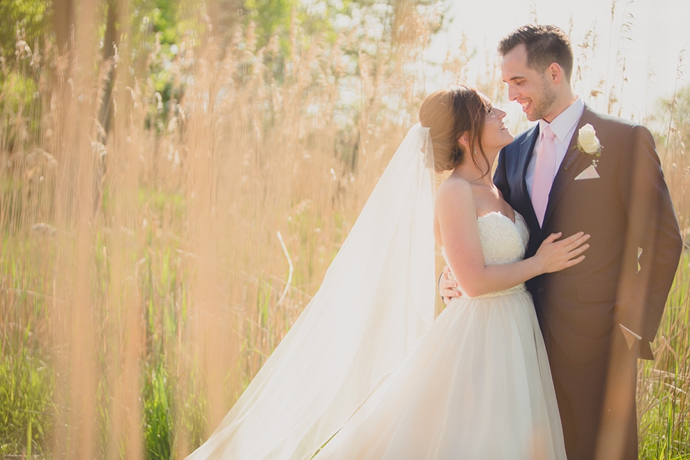 bride and groom embrace at tifft nature preserve during their wedding in Buffalo, NY