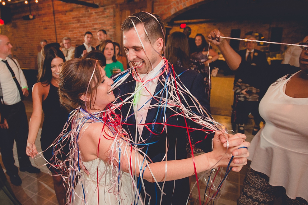bride and groom dance with ribbon wrapped around them at wedding at Pearl Street Grill and Brewery in Buffalo, NY