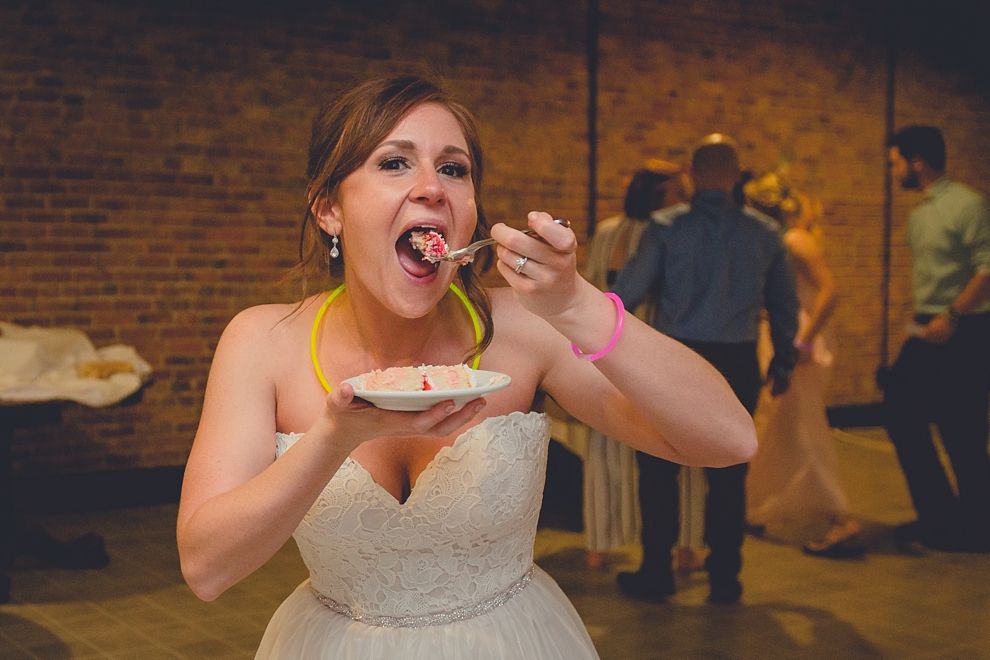 wedding photography of bride eating cake at Pearl Street Grill and Brewery in Buffalo, NY