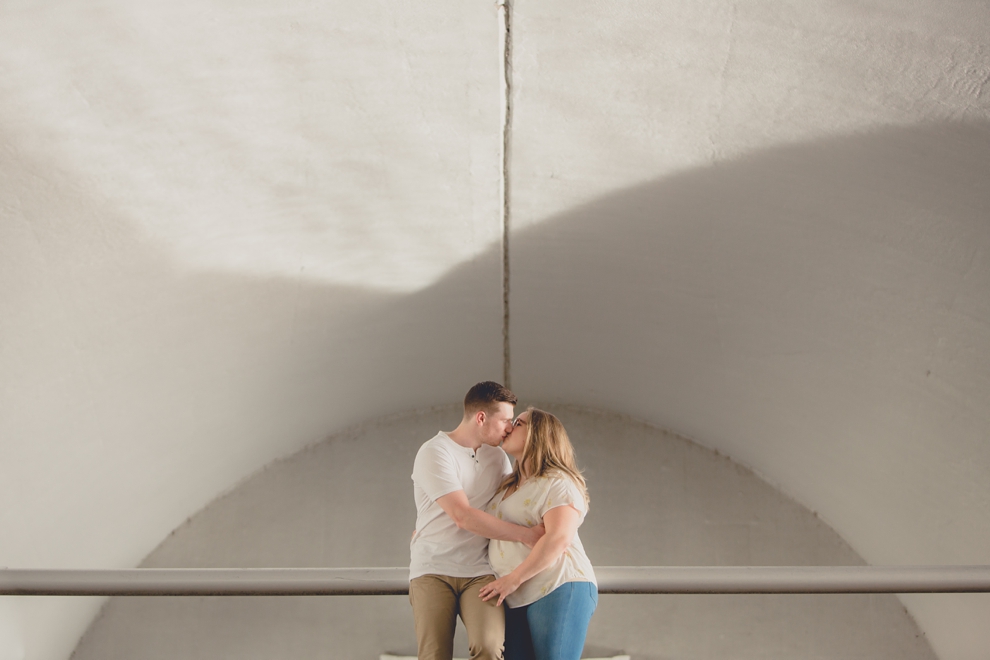 photograph of engaged couple kissing under bride in Point Park in Pittsburgh