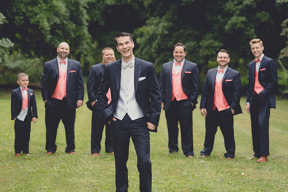 groom smiling in front of groomsmen before garden wedding ceremony at Samuel's Grande Manor near Buffalo, NY