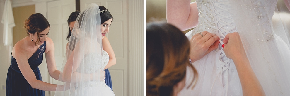 bride getting dress fastened by bridesmaids before garden wedding ceremony at Samuel's Grande Manor near Buffalo, NY