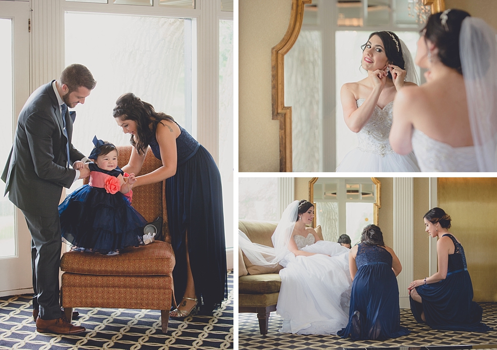 bride putting on earrings and shoes while flower girls parents dress her before garden wedding ceremony at Samuel's Grande Manor near Buffalo, NY