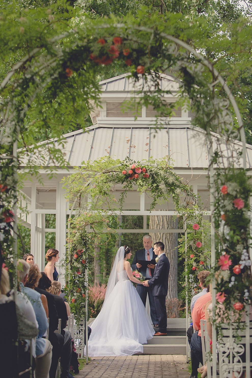 bride and groom exchange vows during garden wedding ceremony at Samuel's Grande Manor near Buffalo, NY