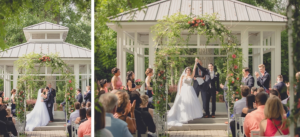 bride and groom share first kiss during garden wedding ceremony at Samuel's Grande Manor near Buffalo, NY