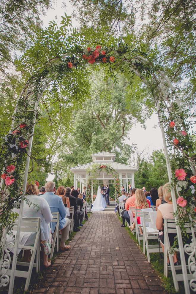 bride and groom say vows during garden wedding ceremony at Samuel's Grande Manor near Buffalo, NY