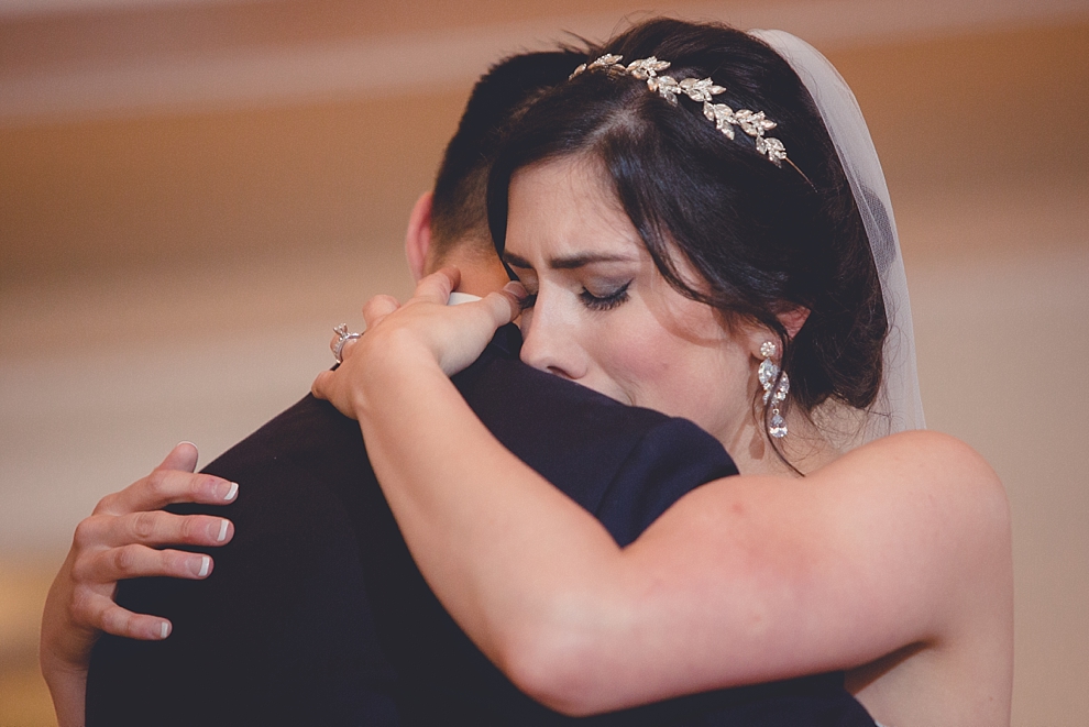 bride cries while sharing first dance with groom during wedding reception at Samuel's Grande Manor near Buffalo, NY