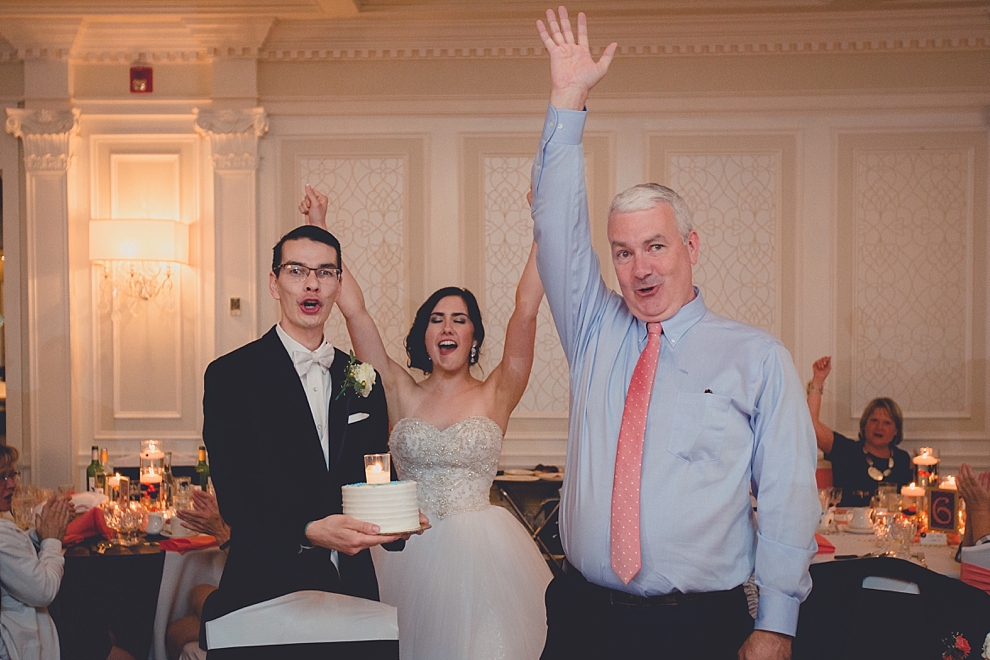 uncle receives brithday cake during wedding reception at Samuel's Grande Manor near Buffalo, NY