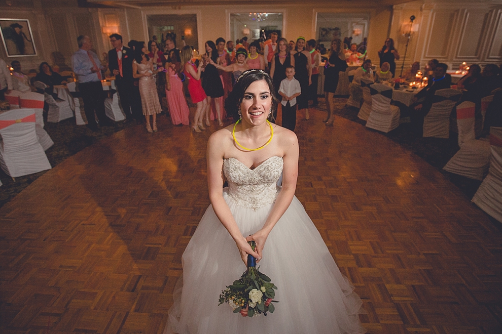 bride tosses bouquet during wedding reception at Samuel's Grande Manor near Buffalo, NY