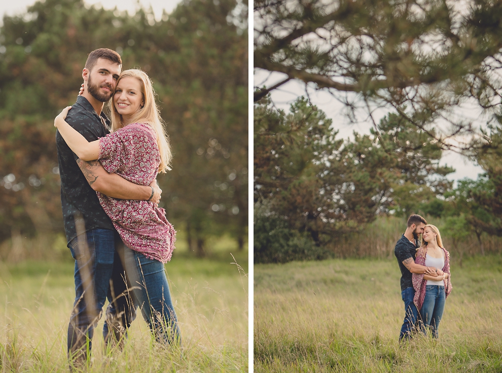 engagement photos of couple in front of pine trees in field at Tifft Nature Preserve in Buffalo, NY