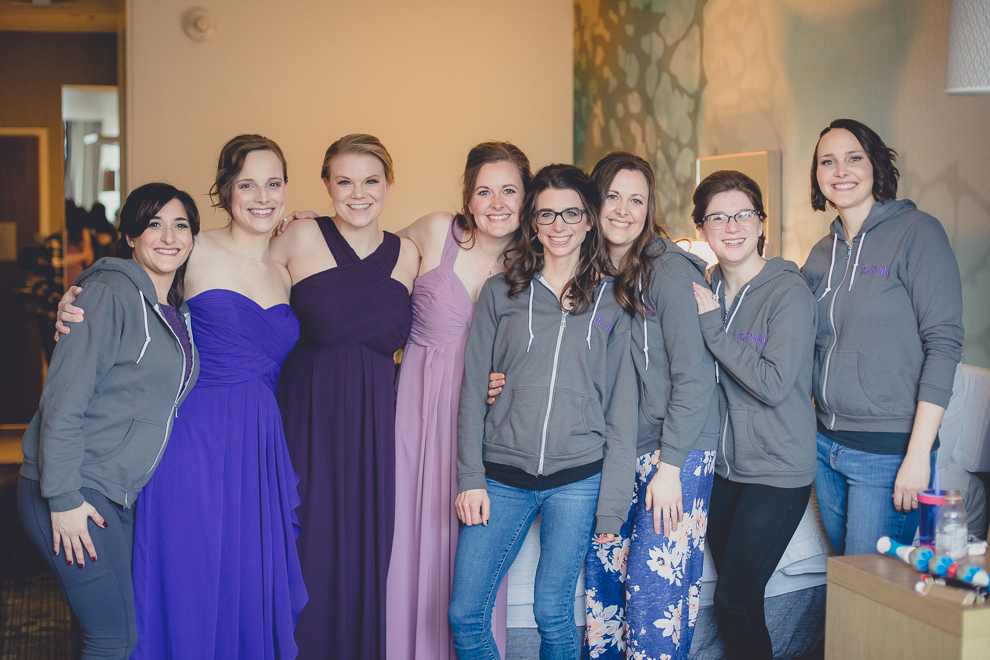 bridesmaids huddle together for a photo before wedding at Marriott Hotel in Buffalo, NY