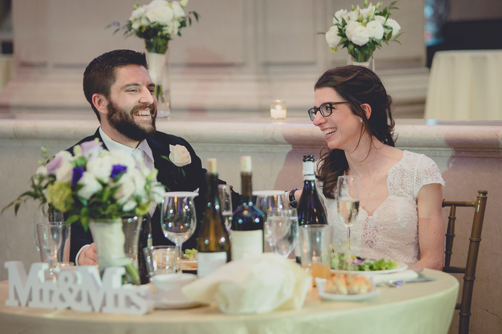 bride and groom laugh during speeches at ballroom wedding reception venue, the Admiral Room, in Buffalo, NY