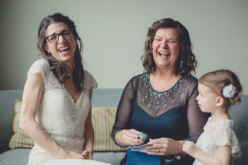bride and mom laugh after receiving wedding gift at Marriott Hotel in Buffalo, NY
