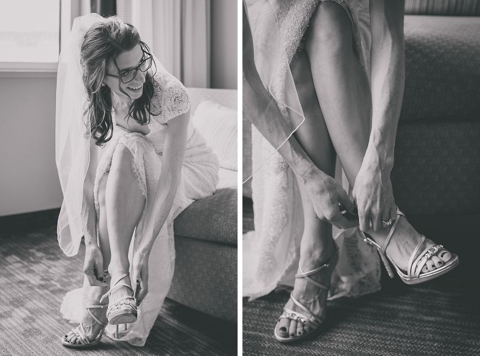 bride puts on shoes as she gets ready for wedding at Marriott Hotel in Buffalo, NY