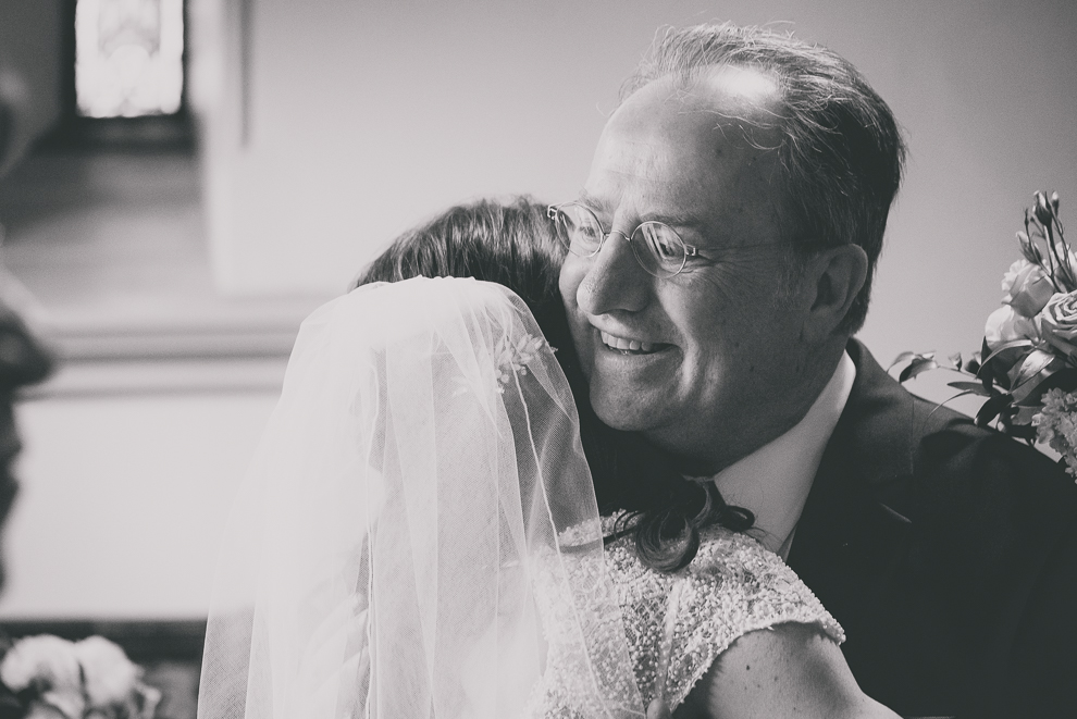 bride hugs father before wedding ceremony at St. Louis Church in Buffalo, NY
