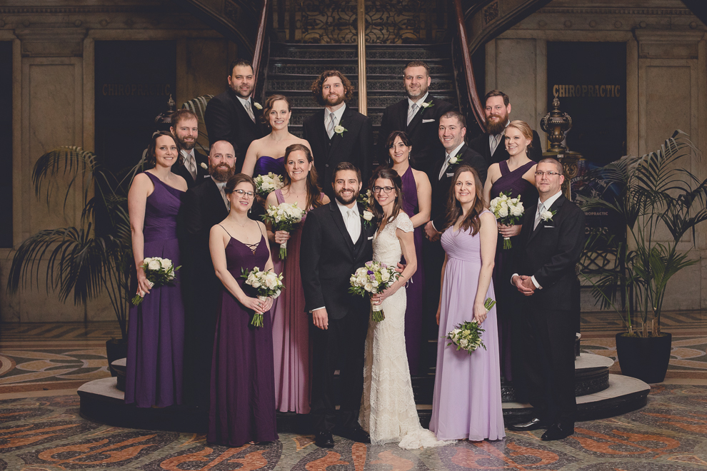 wedding party poses for portrait at Ellicott Square Building during wedding in Buffalo, NY