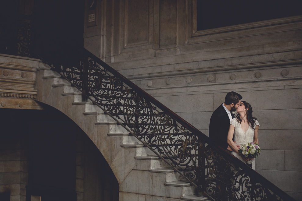 bride and groom pose for portrait at Ellicott Square Building during wedding in Buffalo, NY