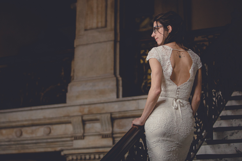 bride poses for portrait at Ellicott Square Building during wedding in Buffalo, NY