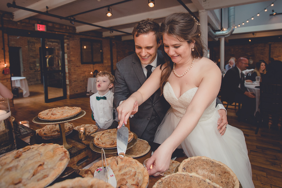 bride and groom cut pie during wedding reception in Hotel Lafayette in Buffalo, NY