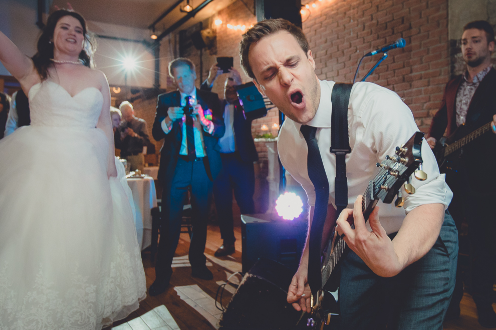 groom plays with James Blonde Band during wedding reception in Hotel Lafayette in Buffalo, NY
