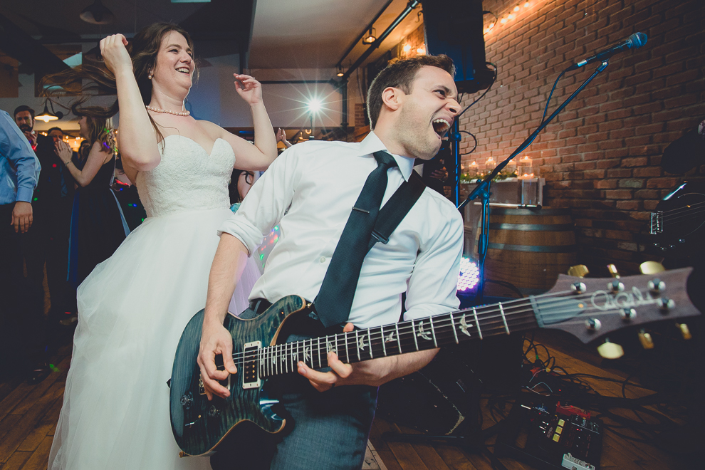 groom plays with James Blonde Band during wedding reception in Hotel Lafayette in Buffalo, NY