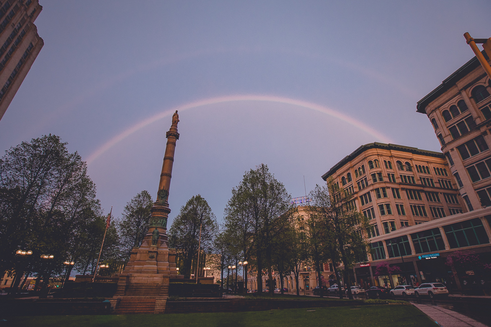 rainbow over exterior of Hotel Lafayette groom plays with James Blonde Band during wedding reception in Buffalo, NY
