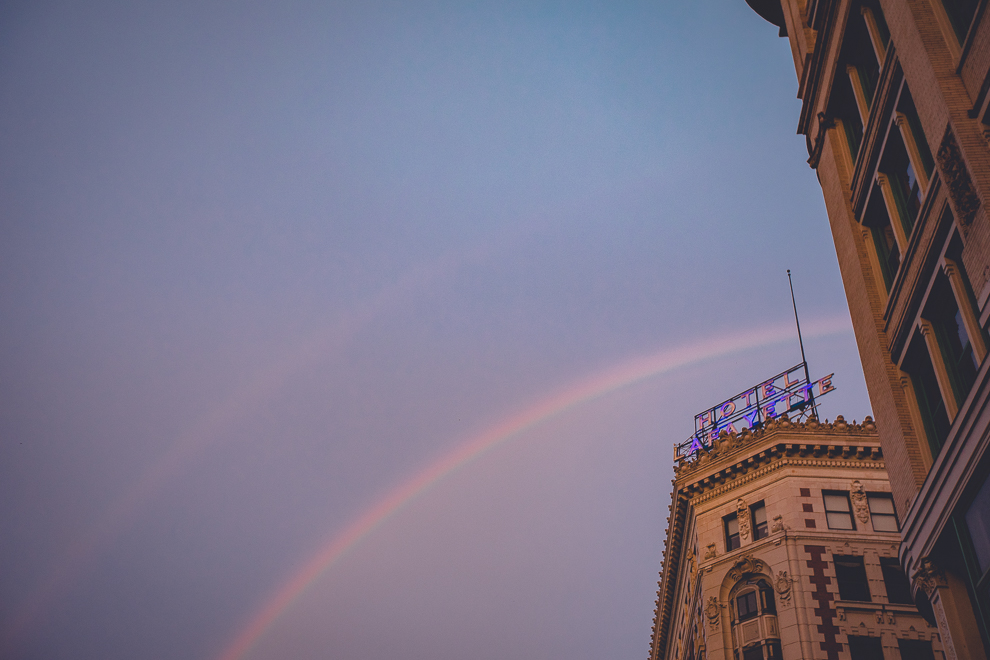 rainbow over exterior of Hotel Lafayette groom plays with James Blonde Band during wedding reception in Buffalo, NY