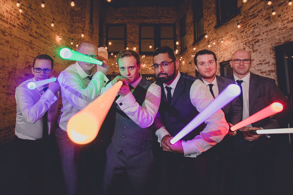 groomsmen pose with star wars light during wedding reception in Hotel Lafayette in Buffalo, NY