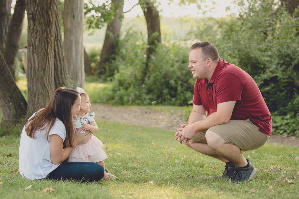 father and daughter make scrunchy faces at each other during family portrait photography session in at Tifft Nature Preserve in Buffalo, NY