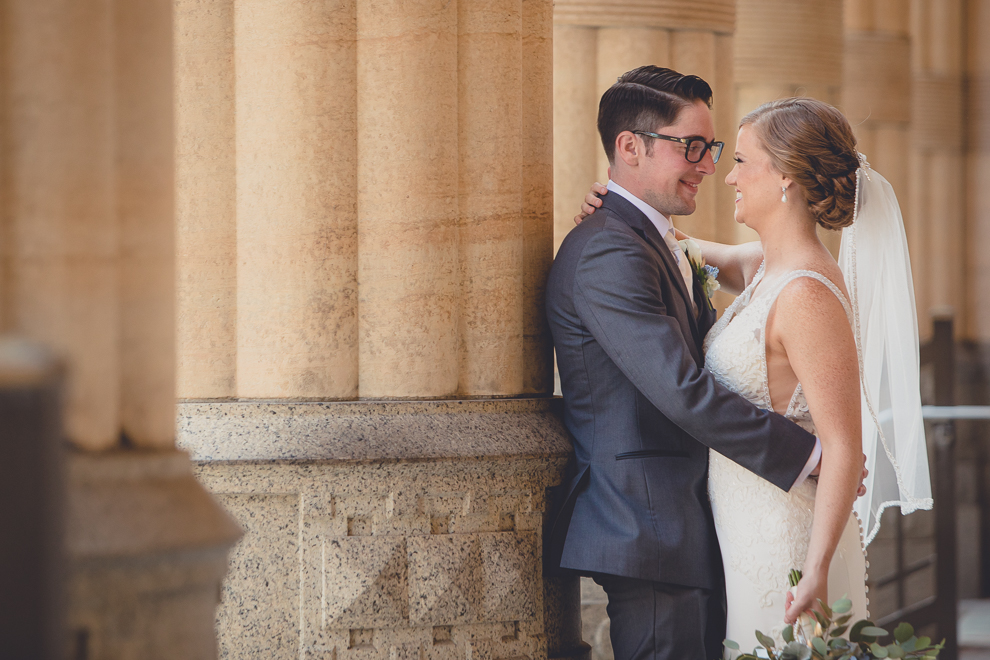 bride and groom pose for portraits at City Hall before their Avanti Mansion wedding in Buffalo, NY