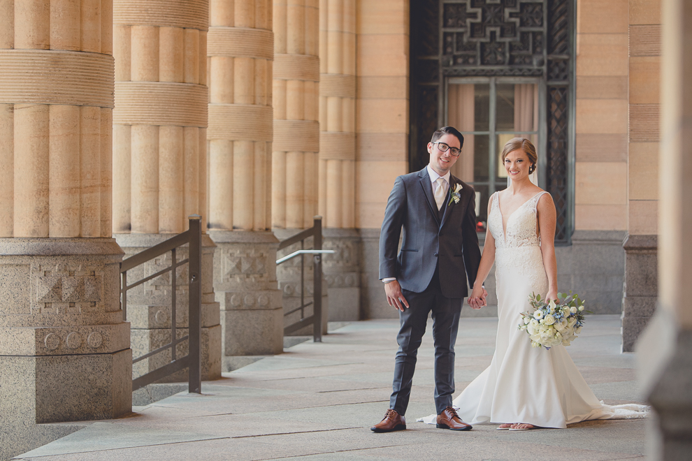 bride and groom pose for portraits at City Hall before their Avanti Mansion wedding in Buffalo, NY