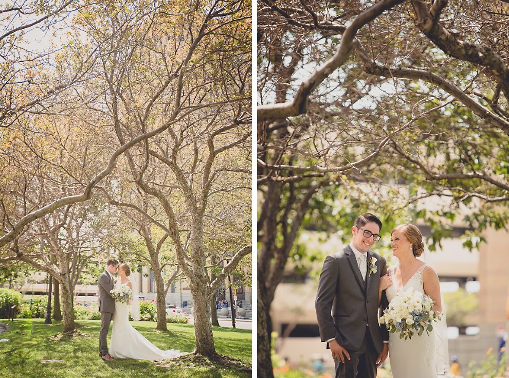 bride and groom pose for portraits at City Hall before their Avanti Mansion wedding in Buffalo, NY