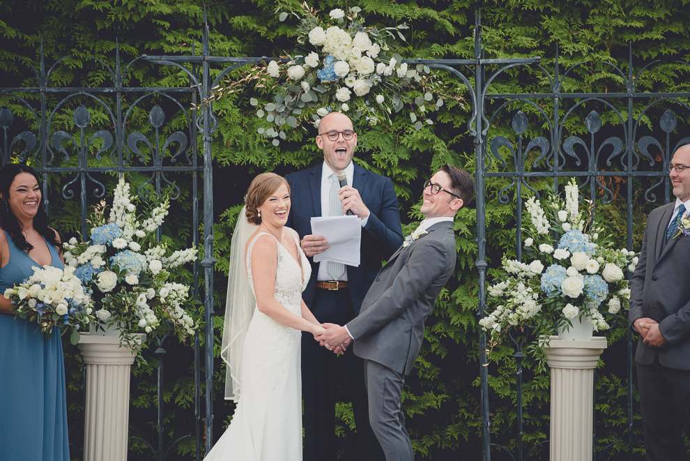 bride and groom laugh during ceremony at avanti mansion wedding in Buffalo, NY
