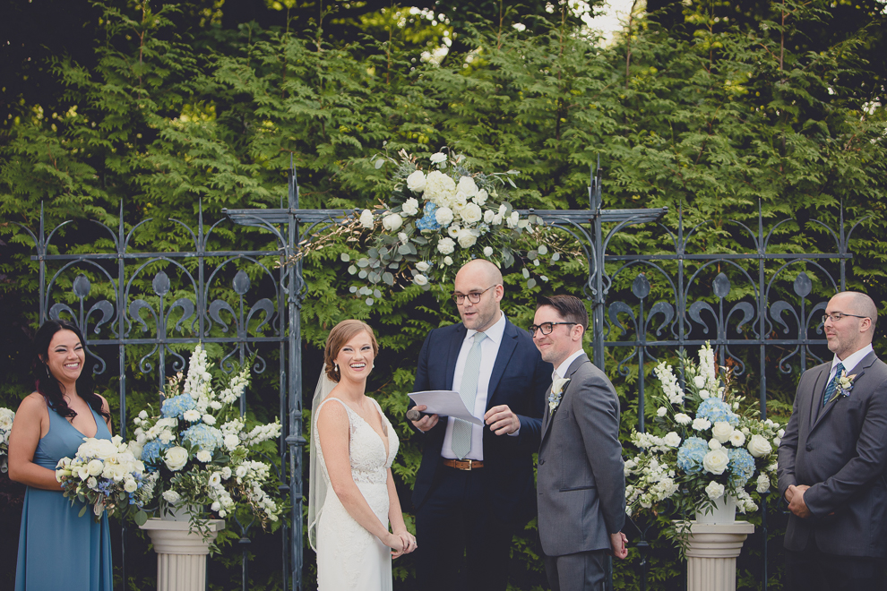 bride and groom laugh during ceremony at avanti mansion wedding in Buffalo, NY