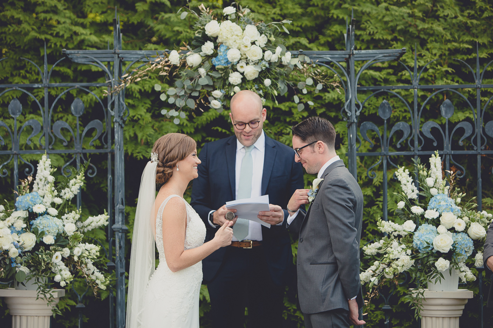 bride and groom laugh during ceremony at avanti mansion wedding in Buffalo, NY
