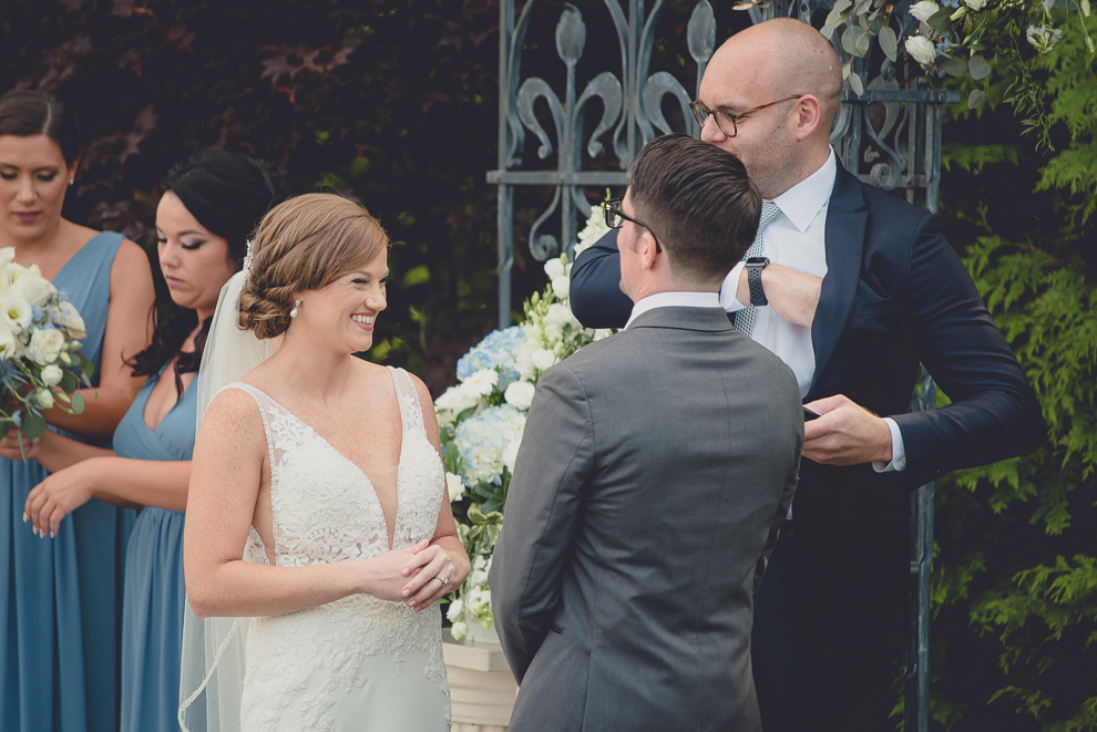 bride laughs during ceremony at avanti mansion wedding in Buffalo, NY