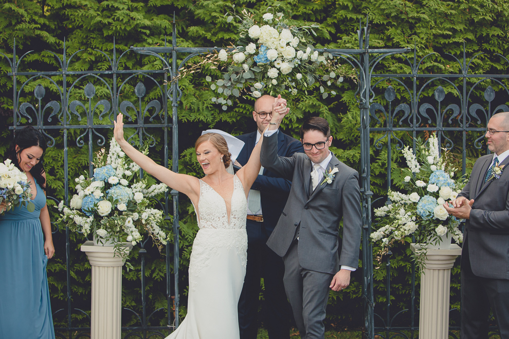 bride and groom celebrate after ceremony at avanti mansion wedding in Buffalo, NY