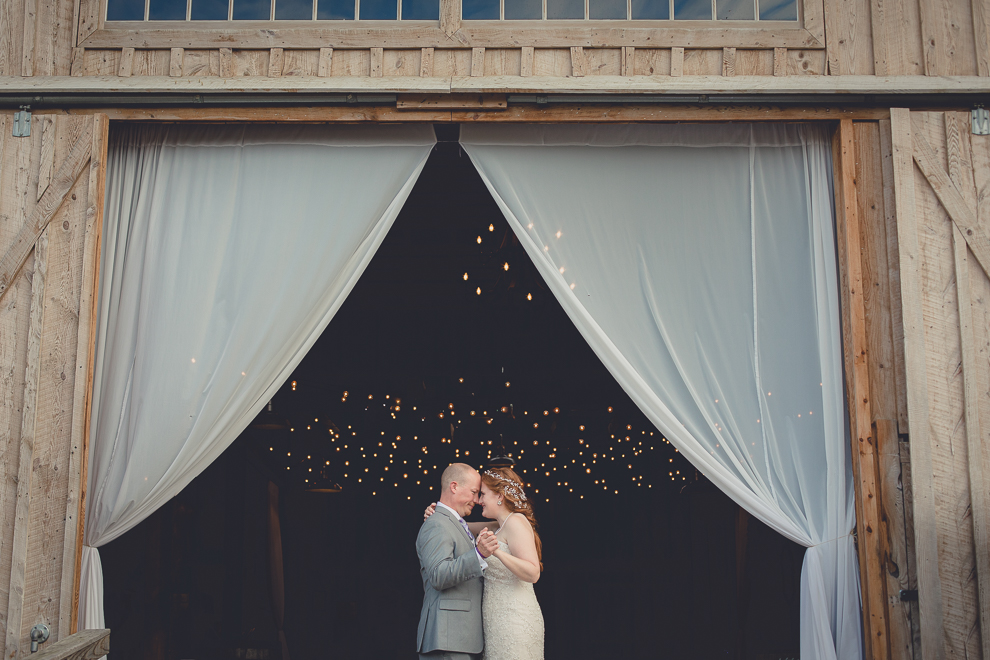bride and groom pose for portraits at sunken pond at a Hayloft in the Grove in East Aurora, near Buffalo, NY