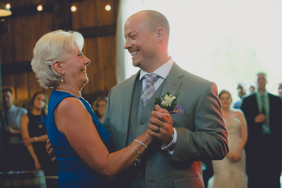 groom and mom dance at wedding reception in barn at a Hayloft in the Grove in East Aurora, near Buffalo, NY
