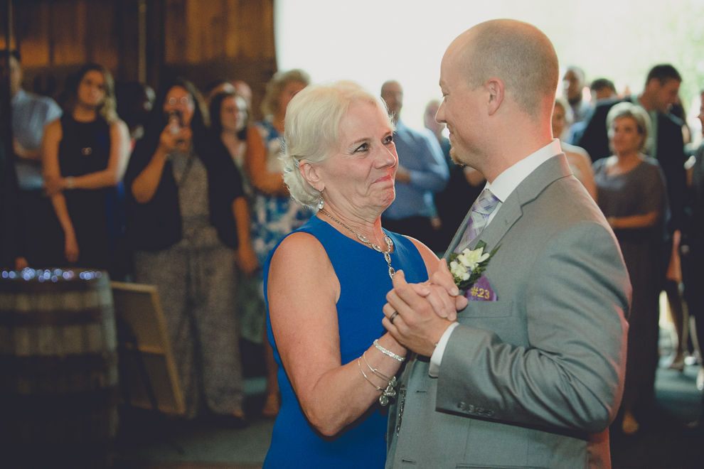 groom and mom dance at wedding reception in barn at a Hayloft in the Grove in East Aurora, near Buffalo, NY