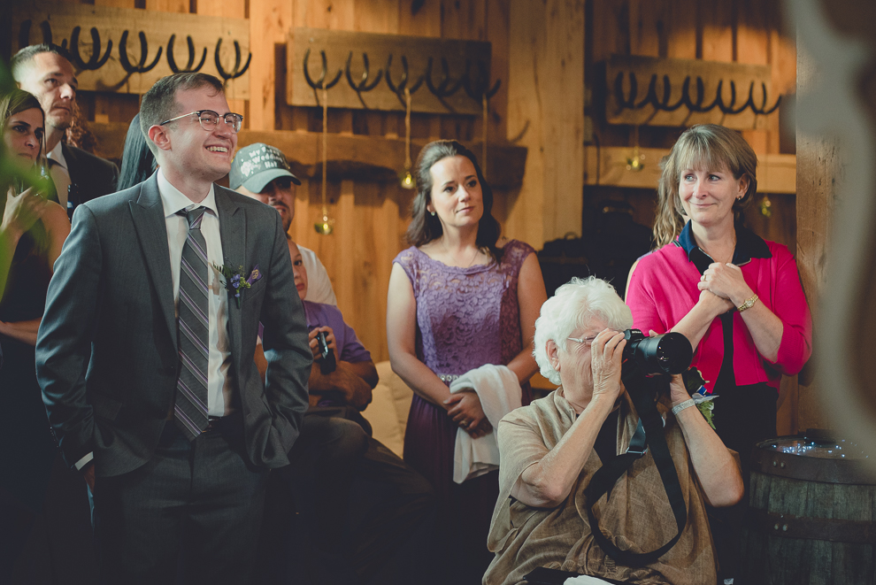 grandma takes photos at wedding reception in barn at a Hayloft in the Grove in East Aurora, near Buffalo, NY