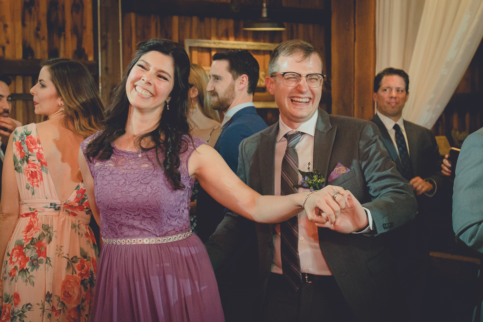 guests dance at wedding reception in barn at a Hayloft in the Grove in East Aurora, near Buffalo, NY